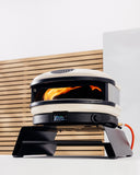 Gozney Arc Booster supporting a lit Bone Gozney Arc XL on a patio counter; oven sold separately