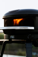 Off Black Gozney Arc XL with an Arc XL Mantel, lit flame and front controls